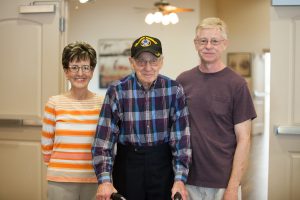 three assisted living residents smiling