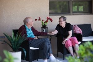 assisted living facility couple holding hands