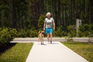 woman in assisted living facility and dog walking