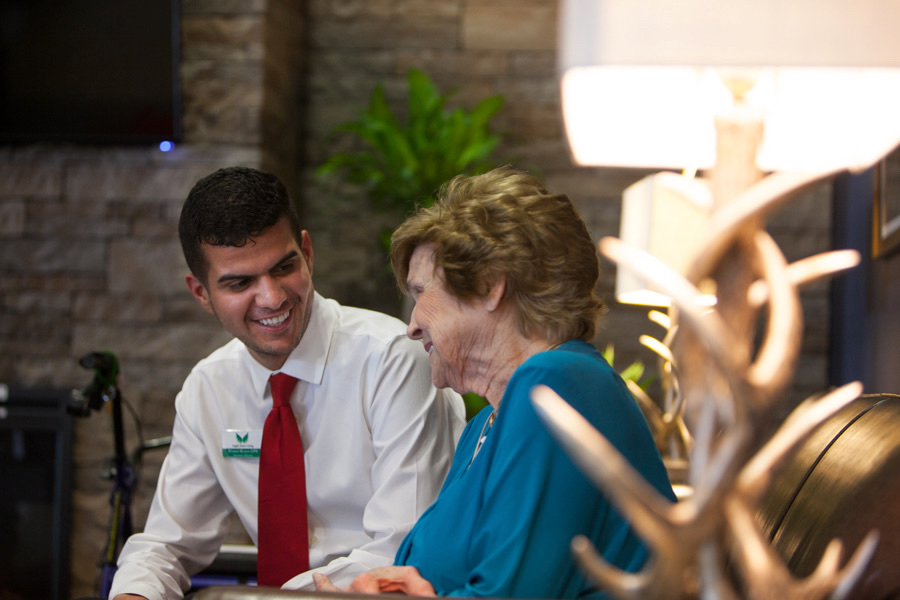 Angels Senior Living Employee Speaking With Senior Resident in Tampa Bay Assisted Living Facility